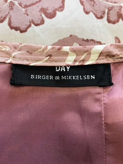 Close-up of a label on a pink floral fabric with 'Birger & Mikkelsen' branding.
