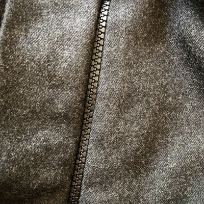 Close-up of a textured fabric with a zipper running vertically.