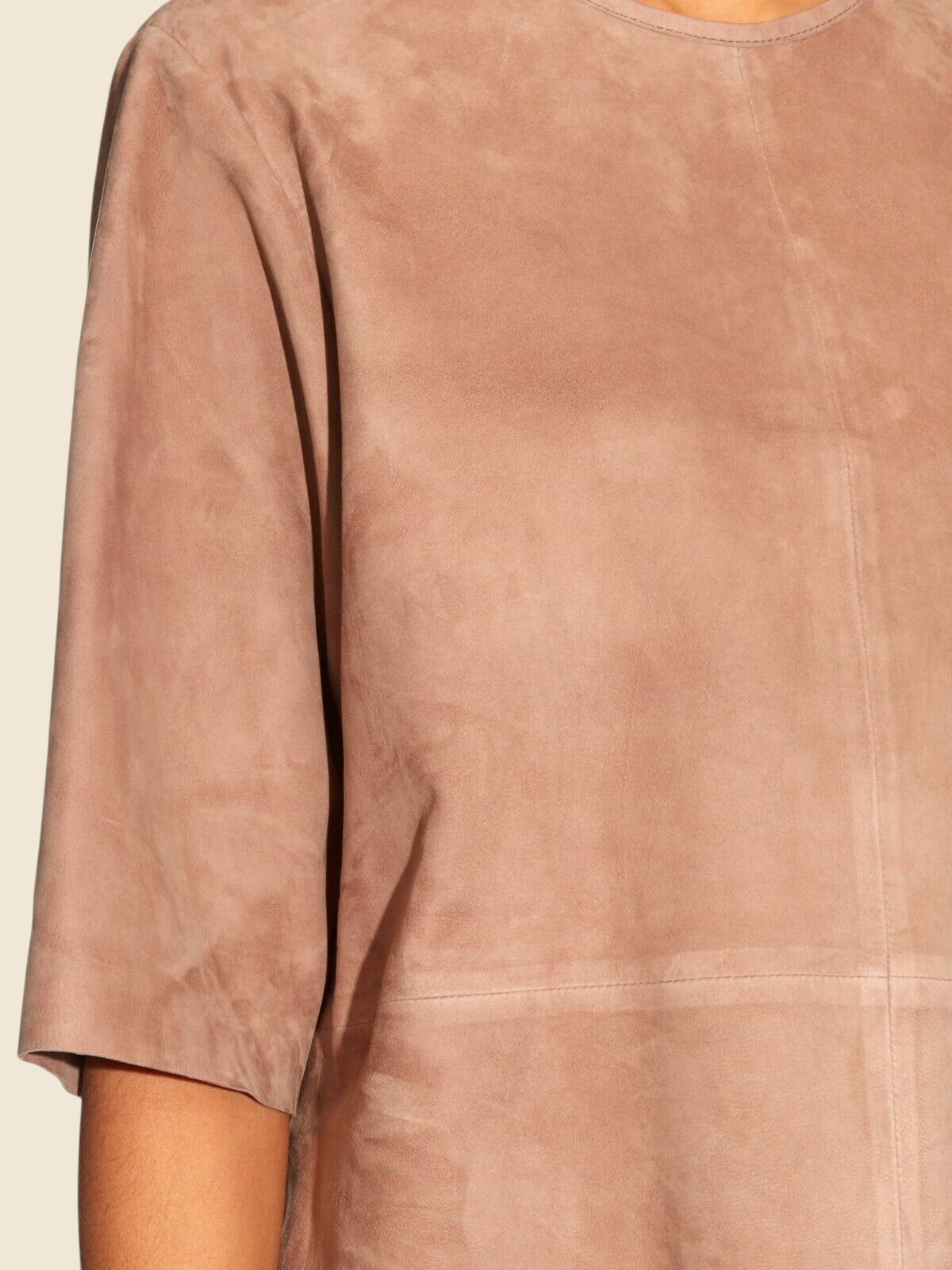 Close-up of a brown suede garment with a neutral background