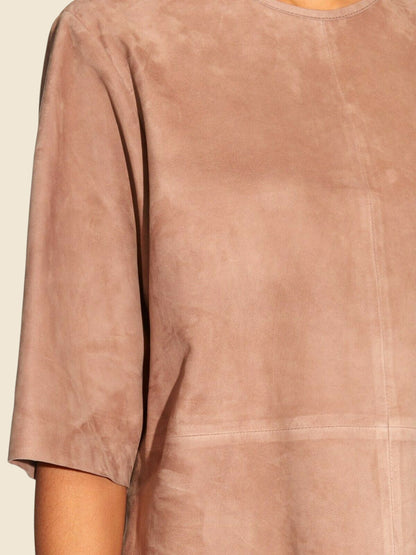 Close-up of a brown suede garment with a neutral background