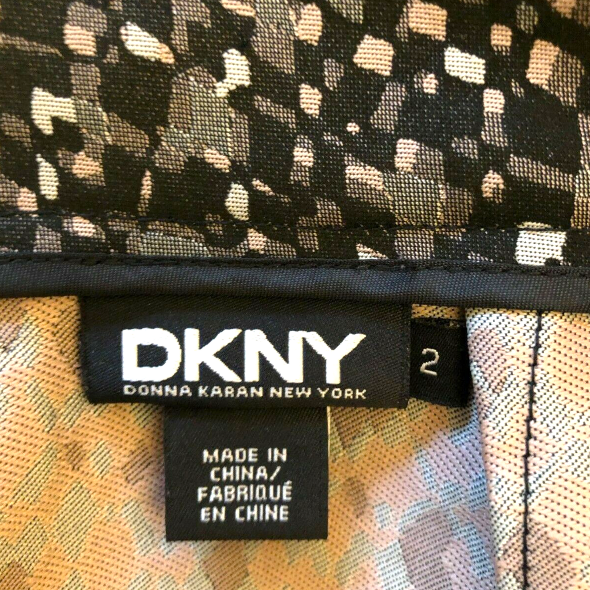 DKNY label on a patterned fabric background