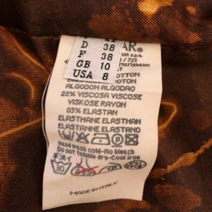 Clothing label on a brown fabric background