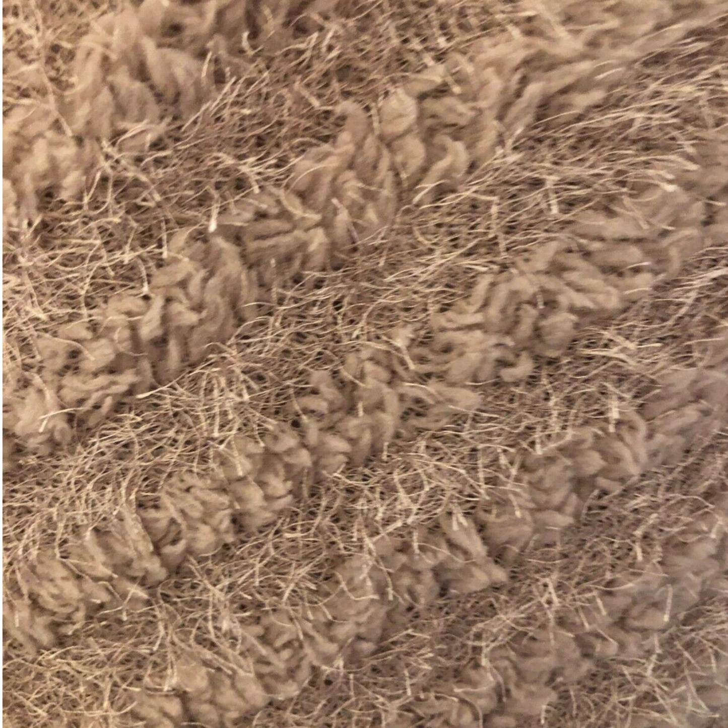 Close-up of a textured brown fabric surface