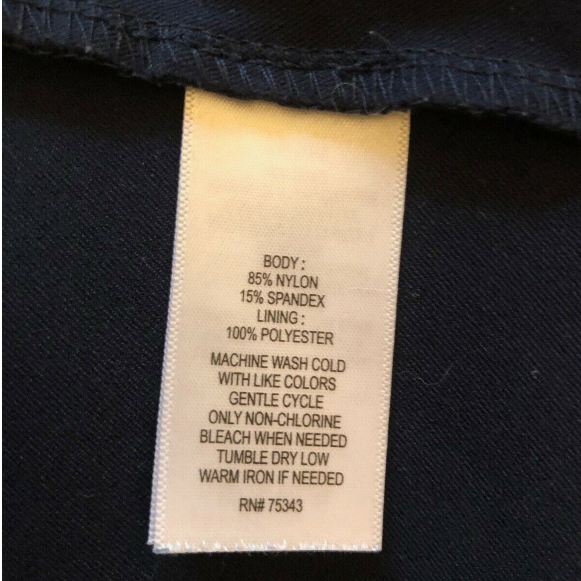 Clothing label with fabric composition and care instructions on a black background