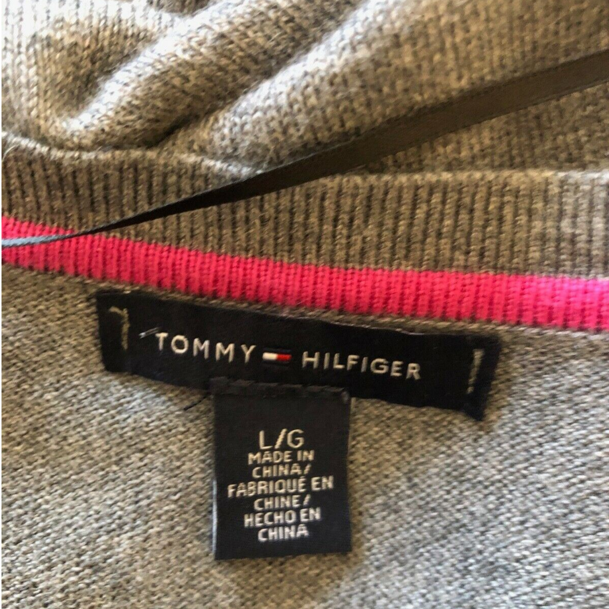 Tommy Hilfiger label on a garment with a pink zipper
