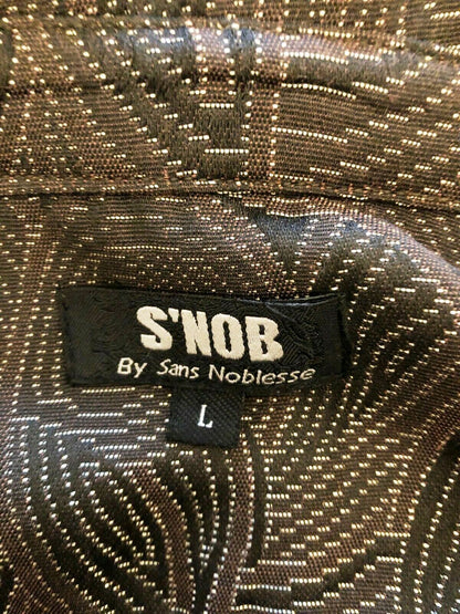 Close-up of a 'S'NOB by Sans Noblesse' label on a patterned fabric.