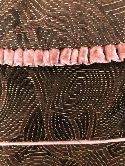 Close-up of a textured fabric with a patterned edge