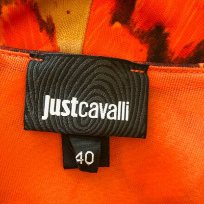 Clothing label with JUST CAVALLI and dress size on orange background