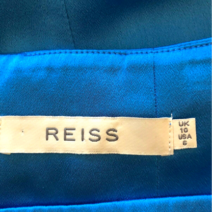 Close-up of a Reiss label on blue fabric