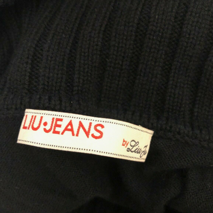 Close-up of a black garment with a 'LIU JEANS' label.