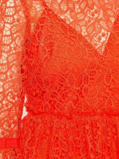 Close-up of red lace fabric with intricate patterns