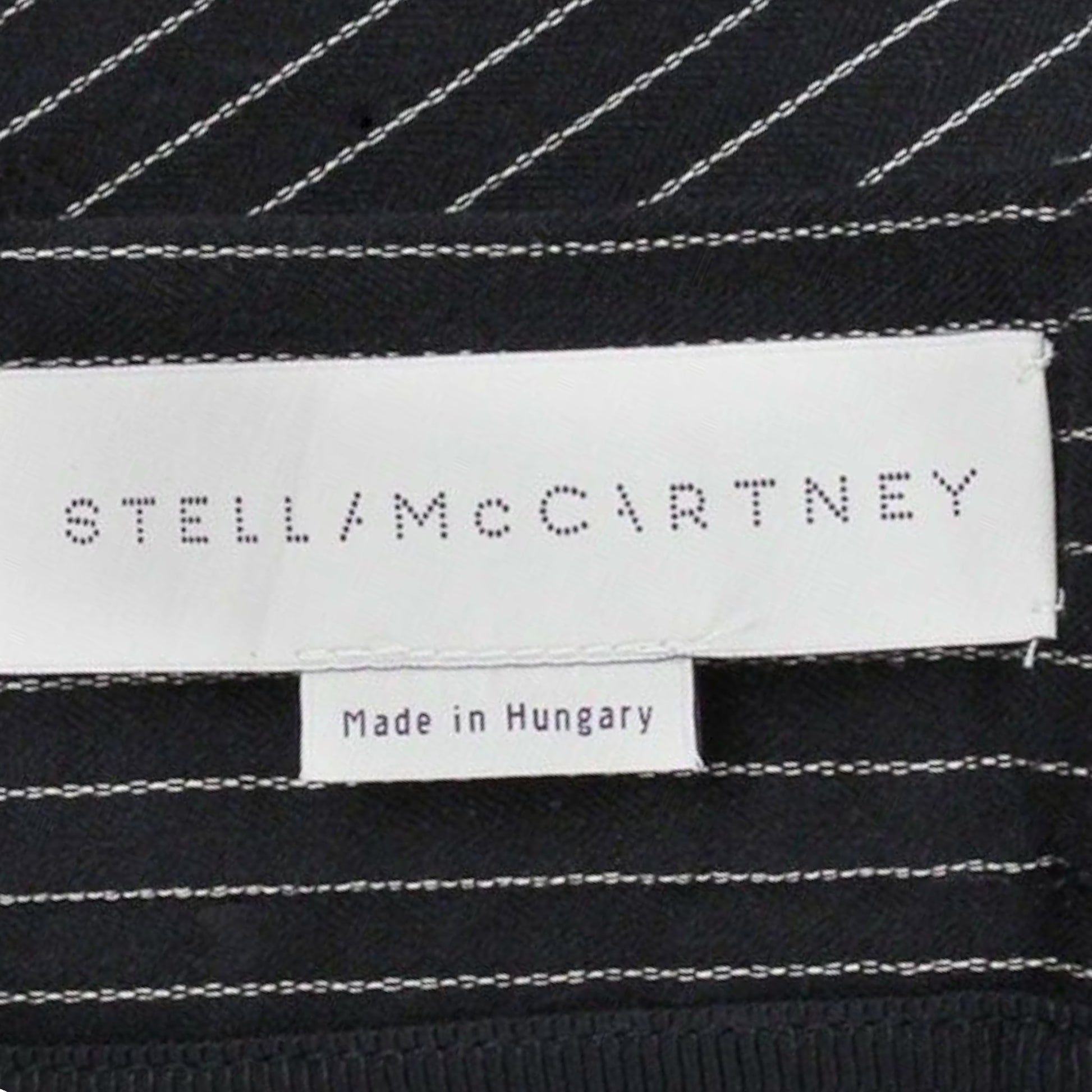Stella McCartney label on black fabric with white stitching