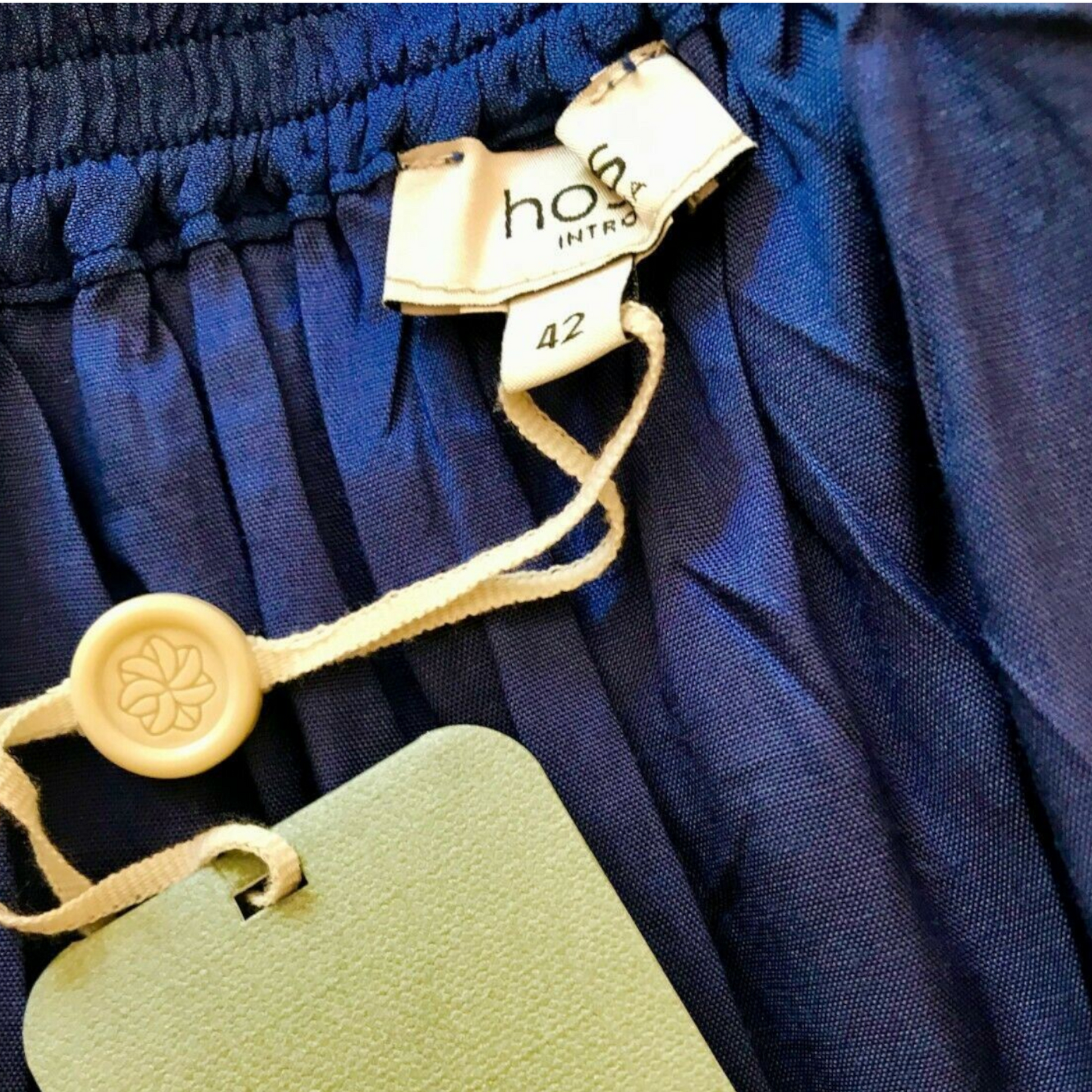 Garment label showing Hoss and garment size on blue background