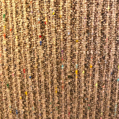 Close-up of a textured brown fabric with colorful specks