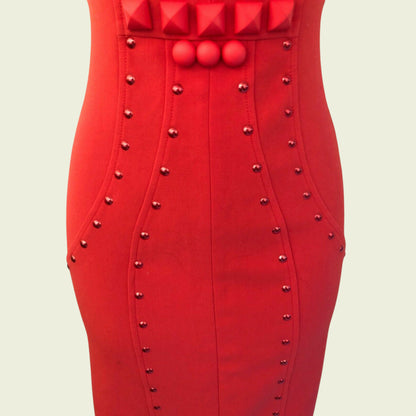 Red dress with studded details on a beige background