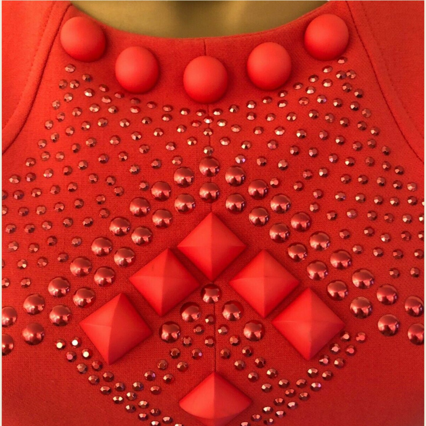 Red fabric with red buttons and studs