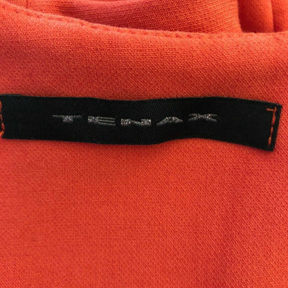 Close-up of a red fabric with a visible brand label.