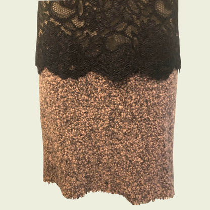 Dress with black lace top and brown textured bottom on a beige background