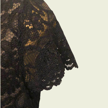 Black lace fabric on a beige background