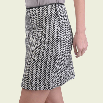 Patterned skirt worn by a person on a light beige background
