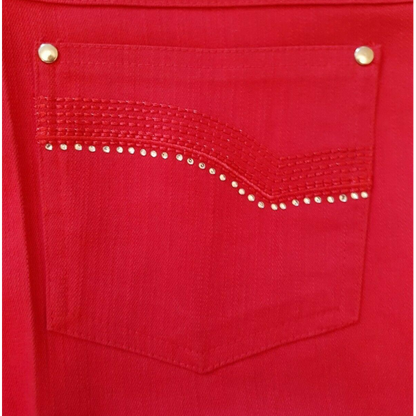 Close-up of a red pocket with decorative studs on a red background