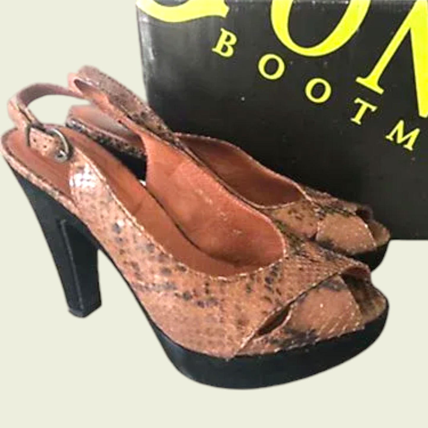Pair of brown open-toe sandals with snake print on a light background