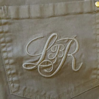 Embroidered pocket with Libra moniker on khaki jeans