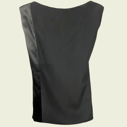 Black sleeveless top on a beige background