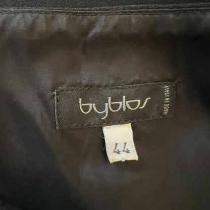 Close-up of a Byblos label on dark fabric