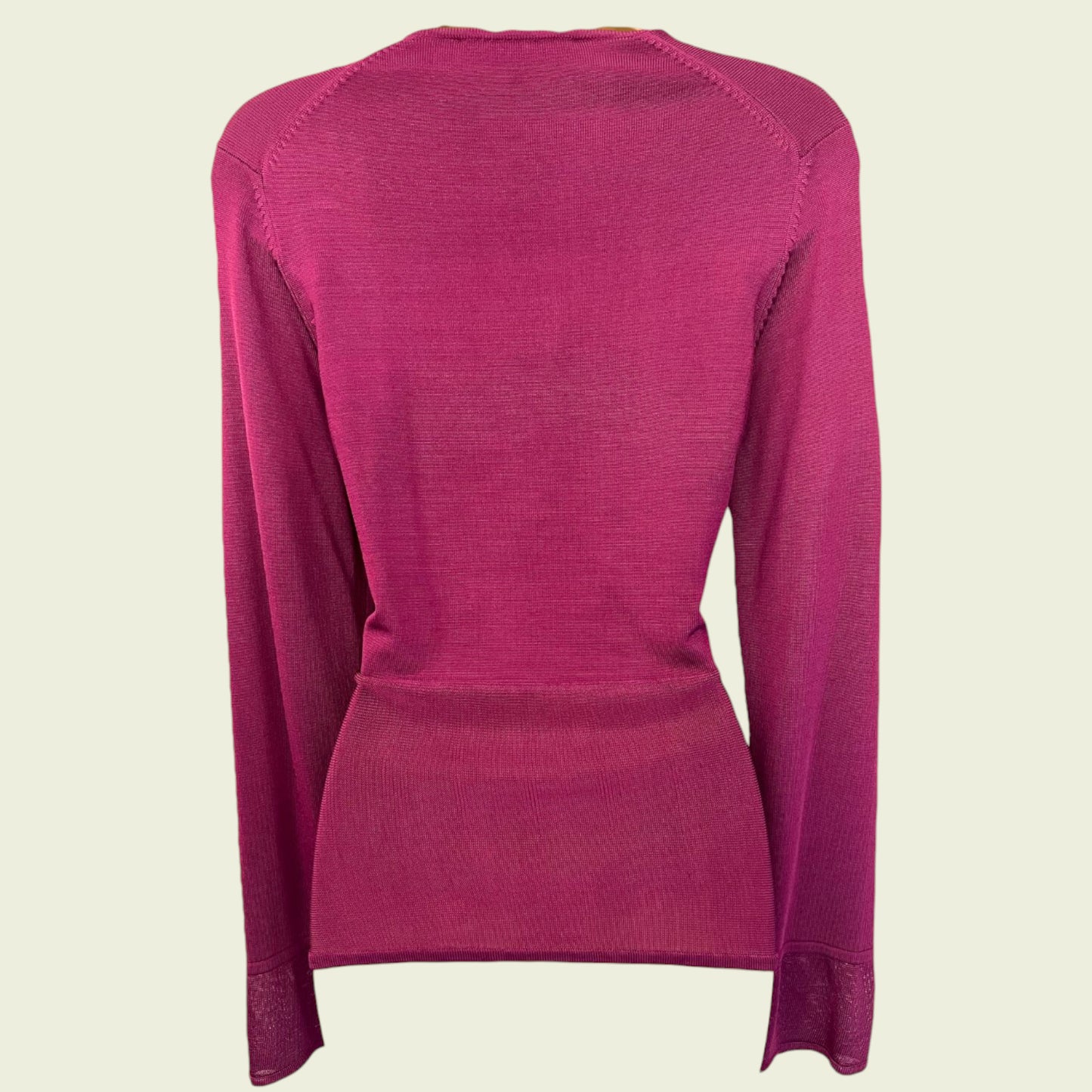 Fuchsia Pink long-sleeve shirt on a beige background