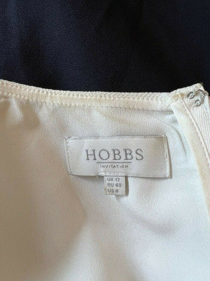Close-up of a cream garment with a Hobbs label on a black background