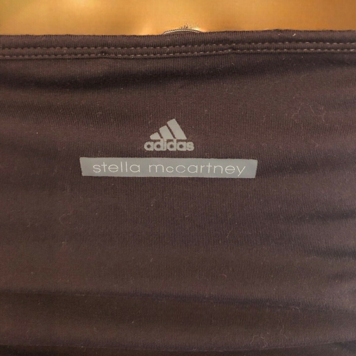 Dark brown top with Adidas and Stella McCartney labels