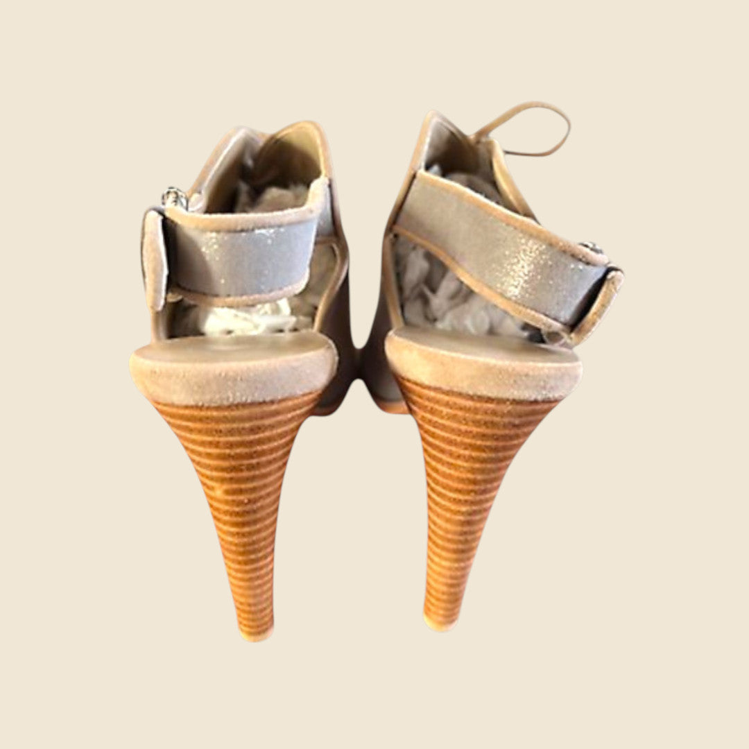 Pair of cone-shaped high-heeled shoes on a beige background