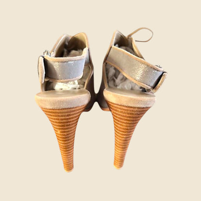 Pair of cone-shaped high-heeled shoes on a beige background
