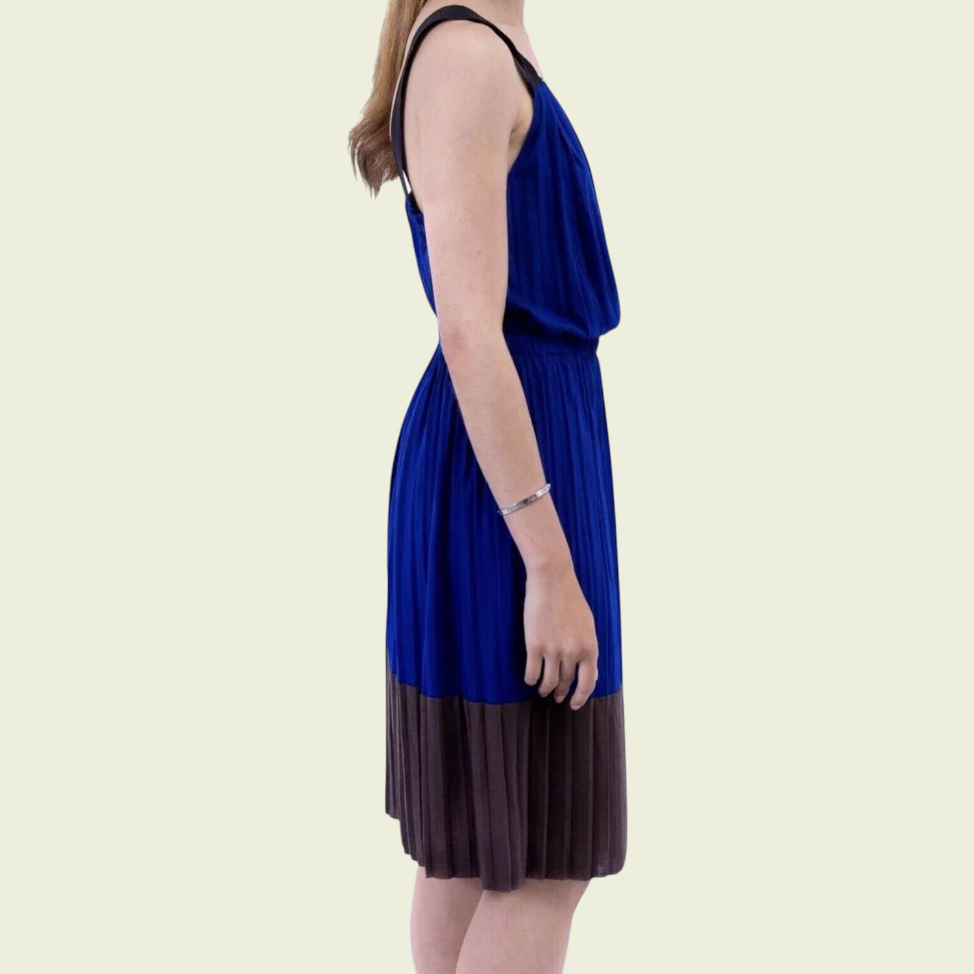 Blue and brown pleated dress on a beige background