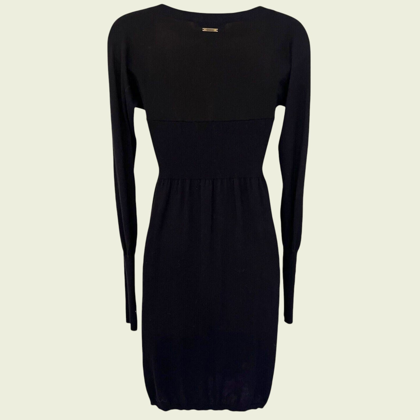 Black dress with long sleeves on a beige background