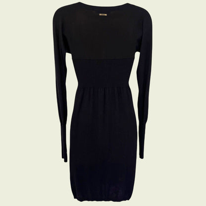 Black dress with long sleeves on a beige background