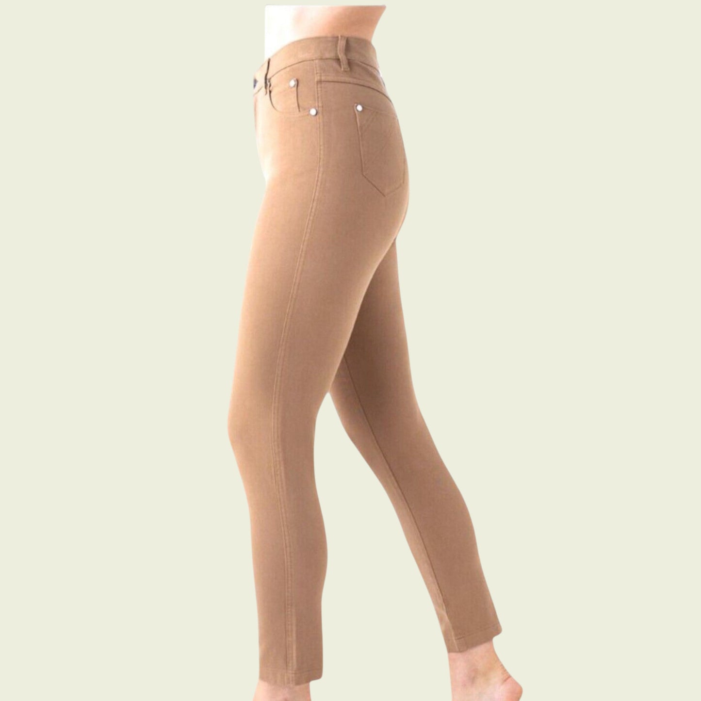 Tan leggings worn by a person on a light beige background