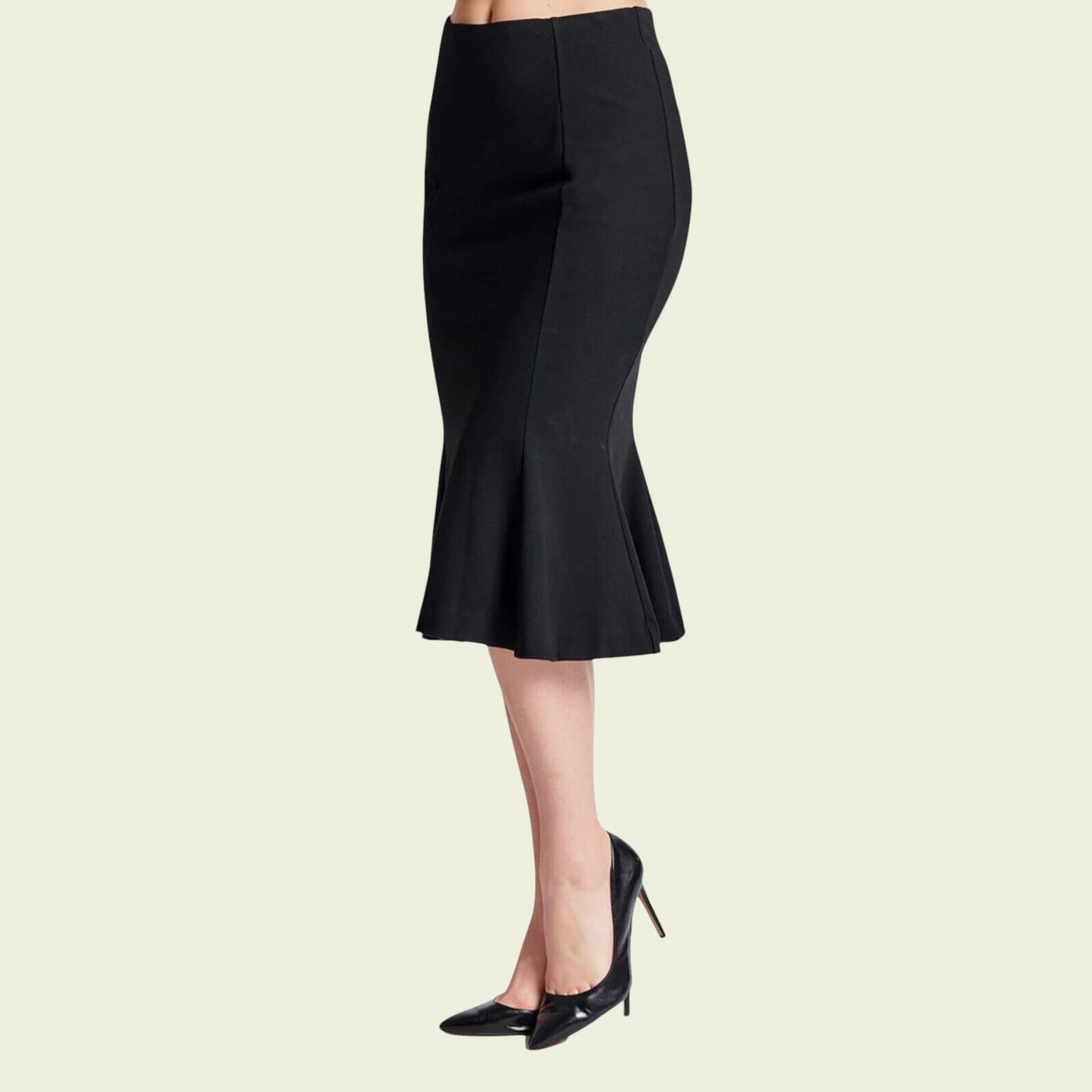 Black pencil skirt worn by a person on a light beige background