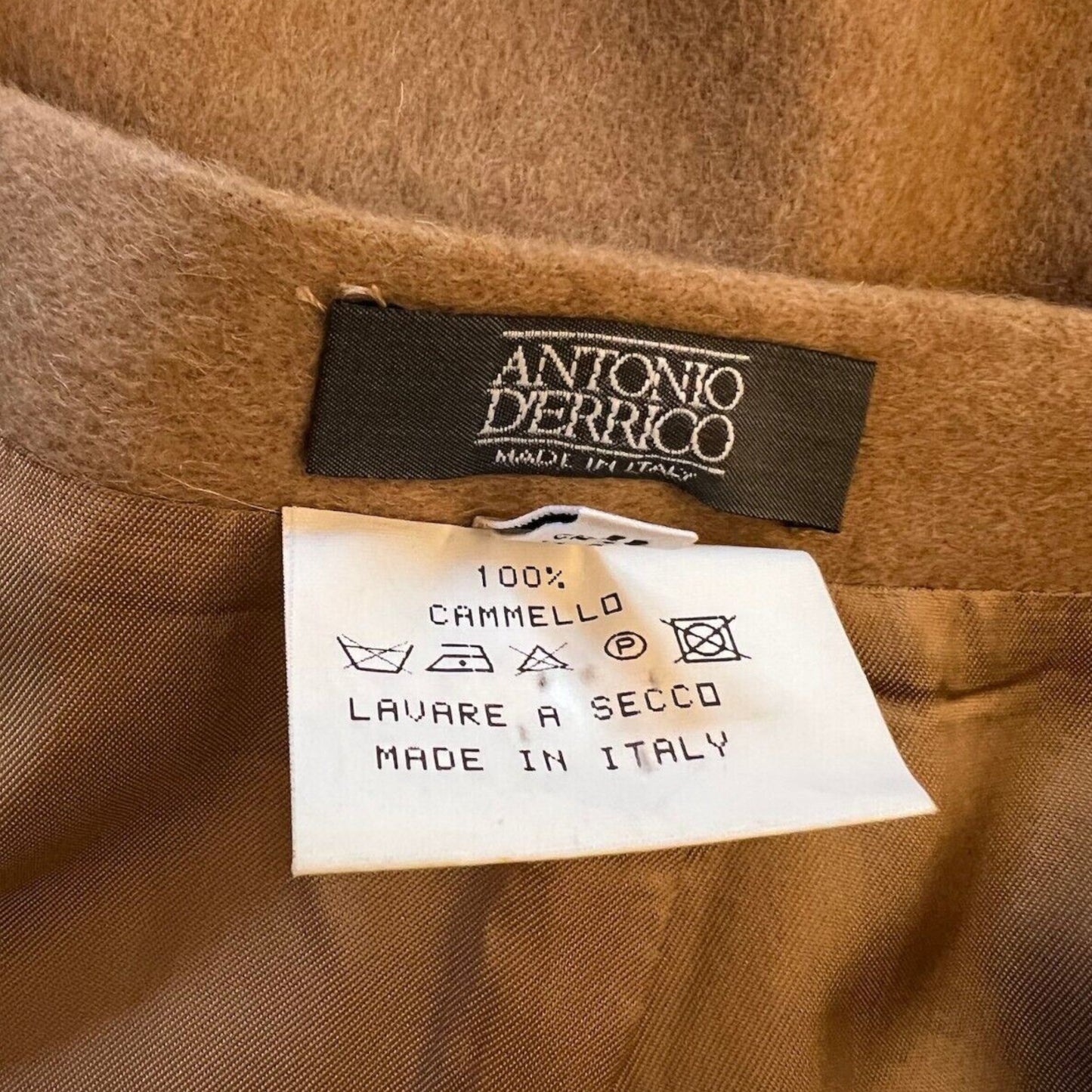 Close-up of a brown fabric with an Antonio Ferrico label and care instructions.