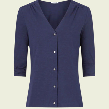 Navy blue carrdigan with buttons on a beige background