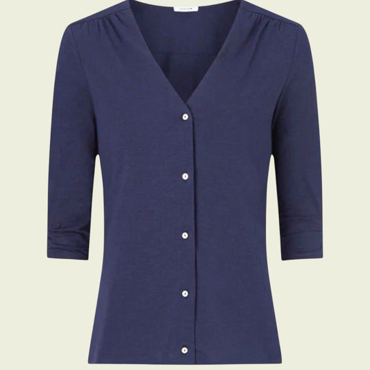 Navy blue carrdigan with buttons on a beige background