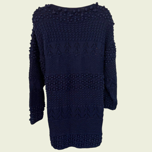 Navy blue knitted jumper on a beige background