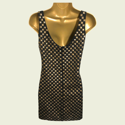 Black and gold patterned tank top on a mannequin against a beige background