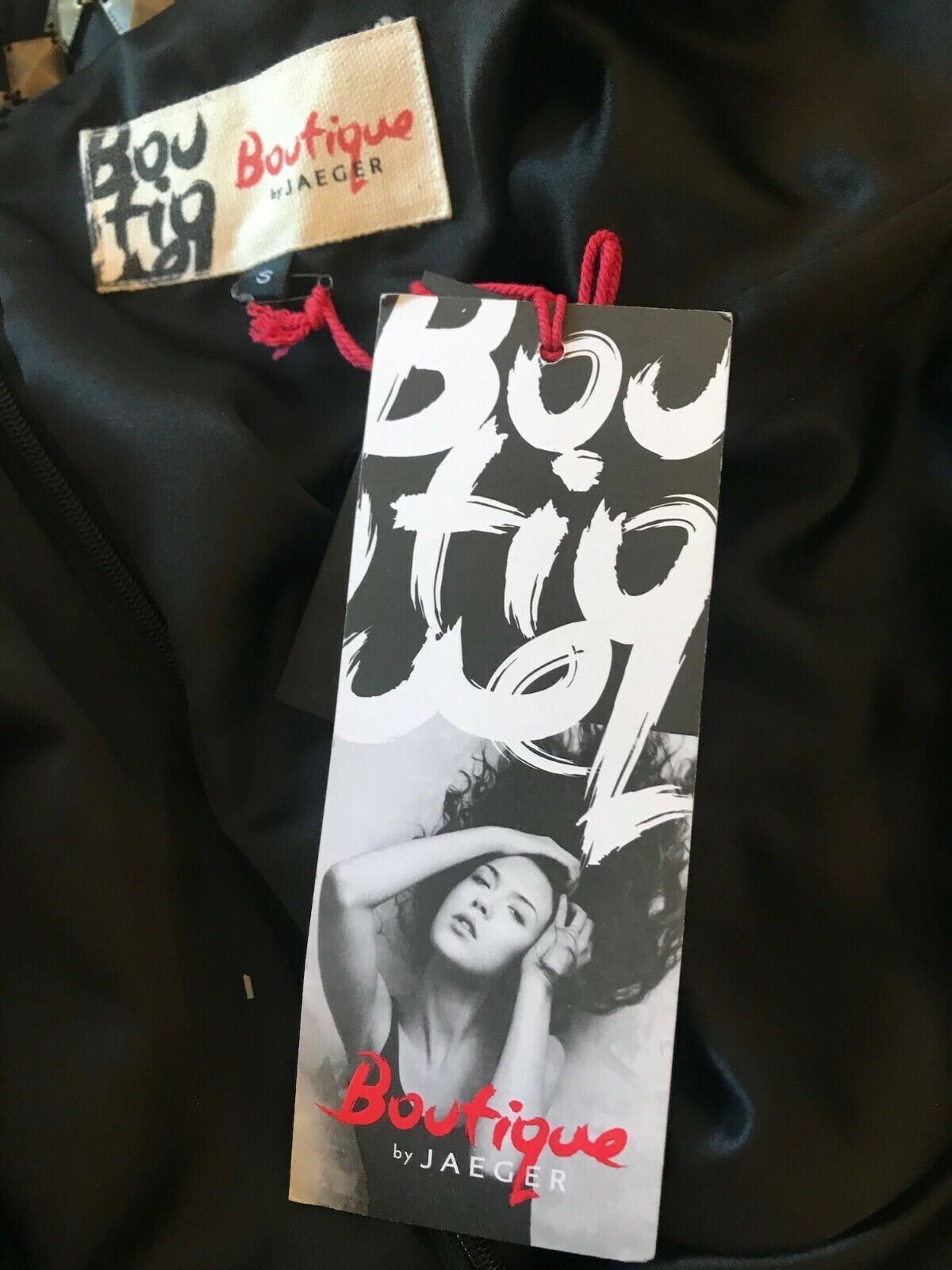 Boutique by Jaeger tag on a black garment with visible branding.