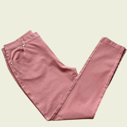 Folded pink pants on a beige background