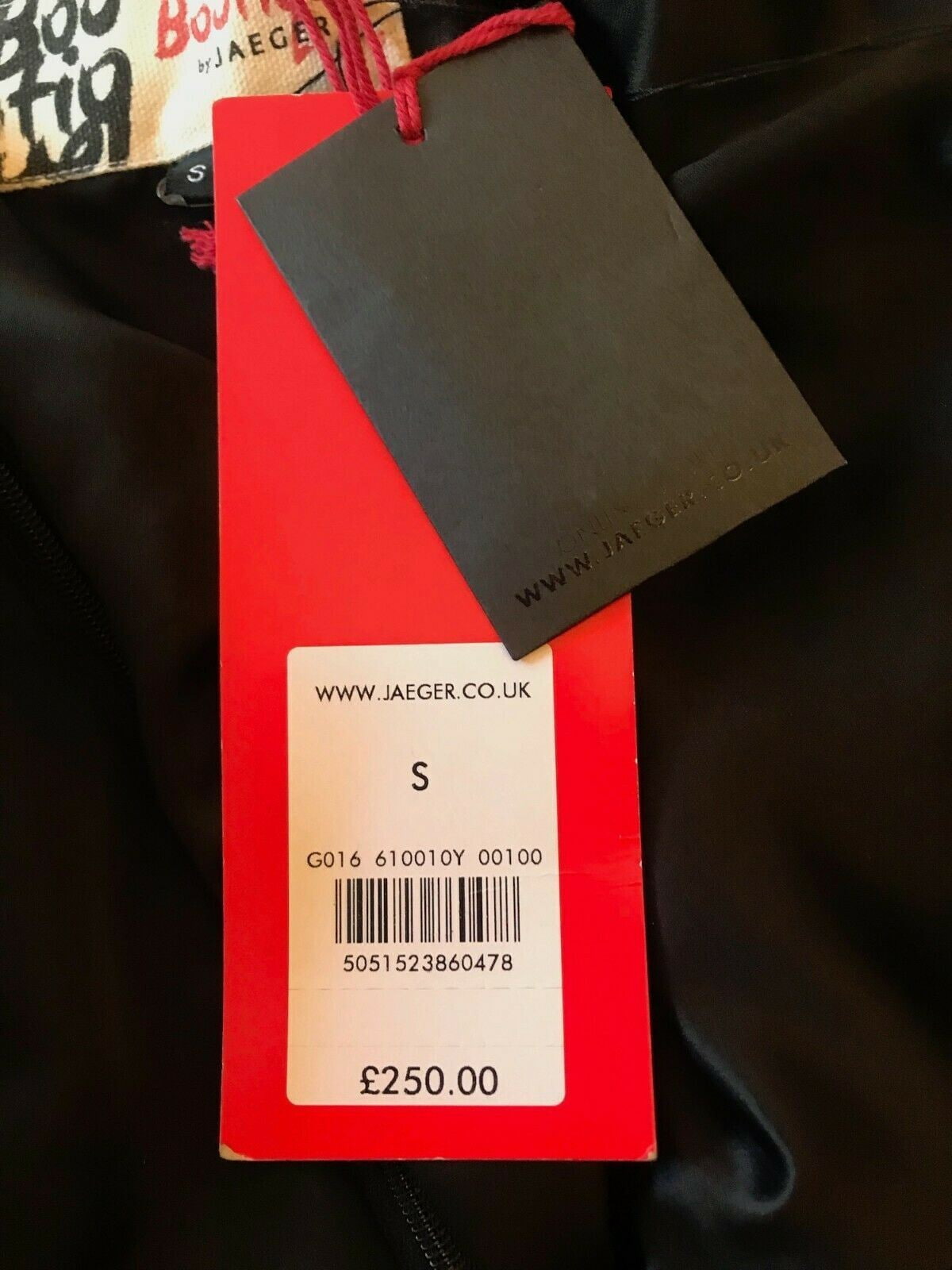 Red tag with a black label on a dark background