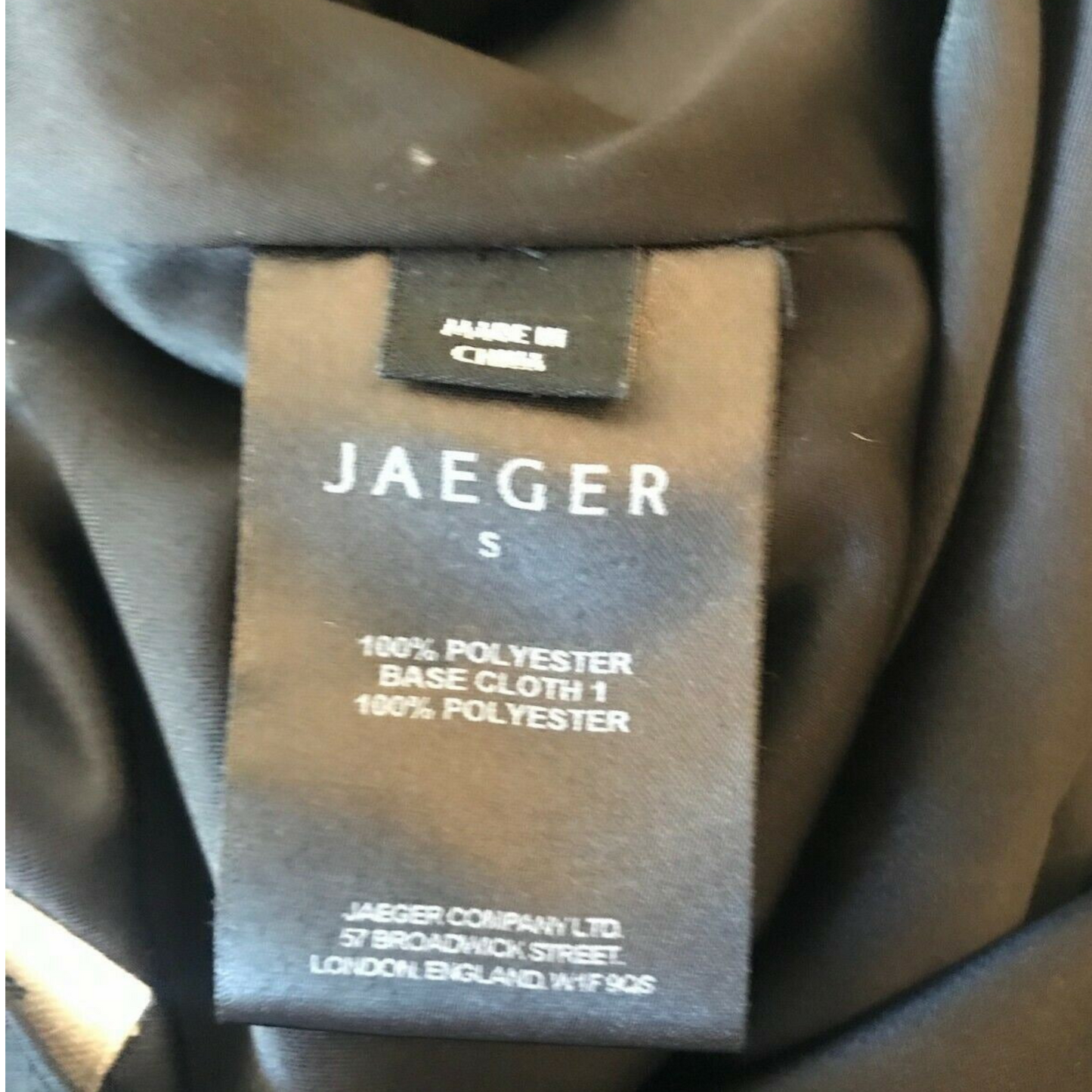 Jaeger label on a garment with text about fabric composition.