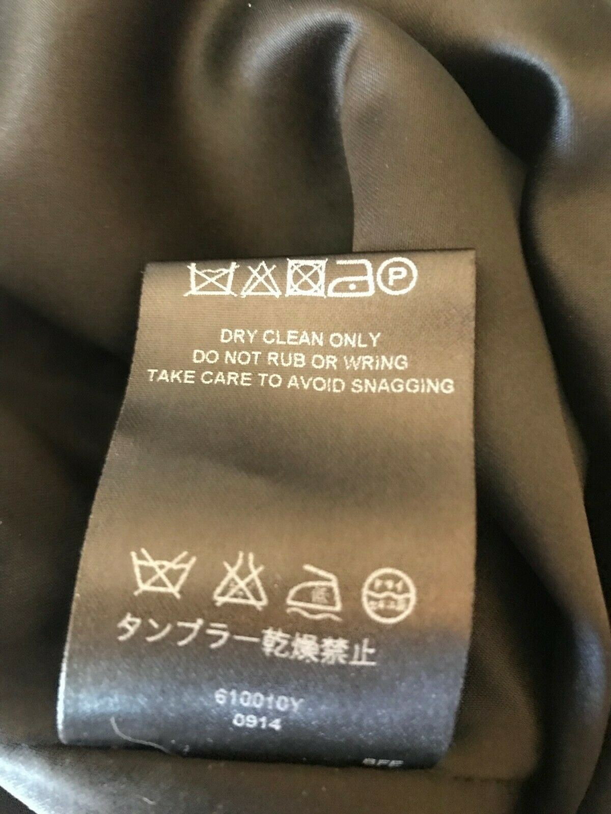 Clothing label on a brown fabric background