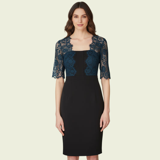 Model wearing black dress with teal lace bolero on beige background